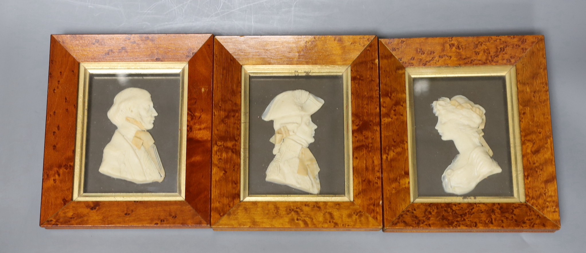 Three Maple framed framed wax portrait reliefs by Leslie Ray, 10 cms high x 8 cms wide